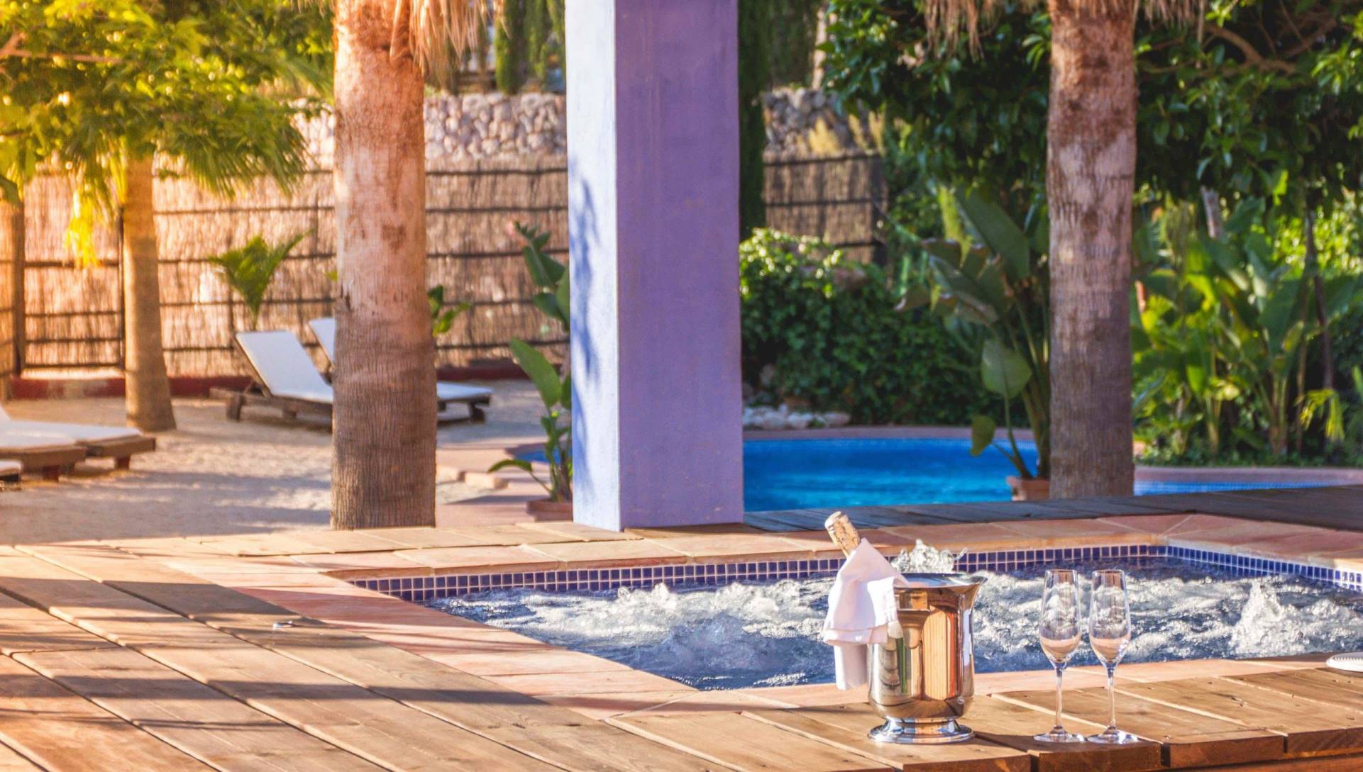 jacuzzi and swimming pool with bottle of champange